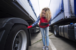 Truck Driver Checking Vehicle Tires